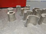 many pieces of metal sitting on a table in a room