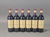six bottles of red wine are lined up in a row
