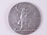 une pièce d'argent sur laquelle figure l'image d'un homme