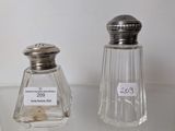 two salt and pepper shakers sitting on a table