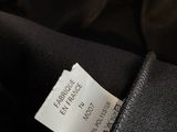 a close up of a label on the back of a black jacket