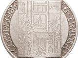 a close up of a silver coin with a drawing on it