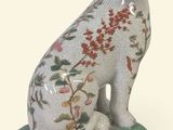 a figurine of a dog sitting on top of a box