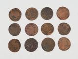 a close up of a bunch of coins on a white surface
