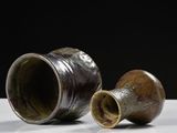 two cups that are sitting on a table