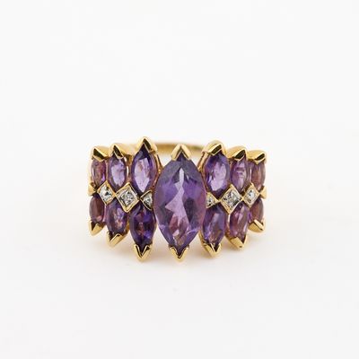 a close up of a gold ring with amethorate and diamonds