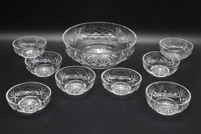 an assortment of glass bowls and bowls sitting on a table