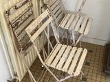 four chairs and a table in the corner of a room