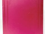 a pink book sitting on top of a white table