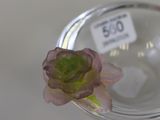 a glass vase with a flower in it on a table