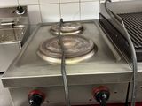 a gas stove with two burners on it in a kitchen