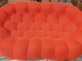 an orange chair sitting on top of a table in a room