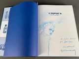 an open book with a drawing of a woman ' s face on it
