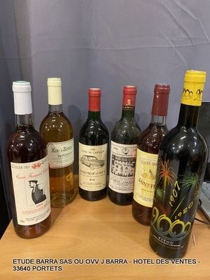 several bottles of wine sitting on top of a wooden table