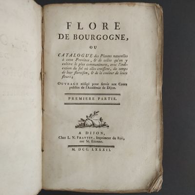 an old book opened on a table with a black background