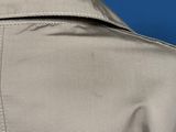 the back of a man ' s jacket with a button on it
