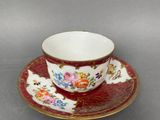 a close up of a cup and saucer on a table