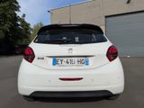 the back of a white car parked in a parking lot