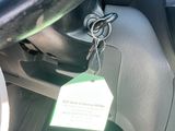 steering wheel of a car with a tag attached to the steering wheel
