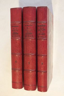 trois livres rouges superposés sur une surface blanche