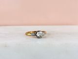 a close up of a diamond ring on a marble surface