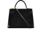 a black handbag with a gold chain on the handle