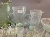 many glasses and pitchers sitting on a table