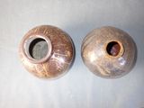 two vases that are sitting on a table