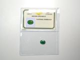 a close up of a piece of green jade on a white surface