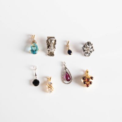 a close up of a white surface with several different types of jewelry