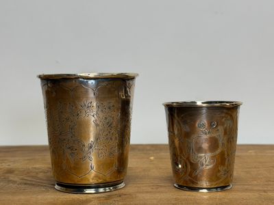 two cups that are sitting on a wooden table