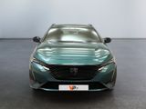 the front of a green car in a room with a white wall