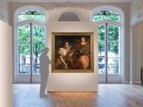 a large painting hanging on the wall in a large room