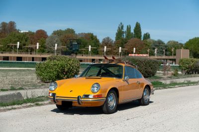 a yellow car that is parked on the side of the road