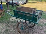 a green wagon with a wooden box in it