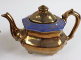 a blue and gold teapot next to a blue and gold tea pot