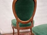 two chairs that are sitting on a red rug