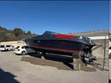 two pictures of a boat on a trailer in a parking lot