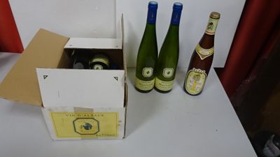 three bottles of wine sitting in a box on a table