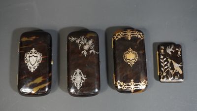 three lighters with designs on them sitting next to each other