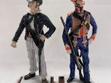 pair of figurines of two men dressed in military uniforms