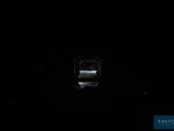 a small window in the dark with a clock on it