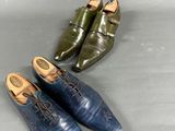 three pairs of blue and green shoes sitting on a gray surface