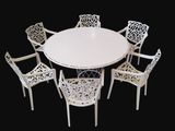 a white table with six chairs around it on a black background