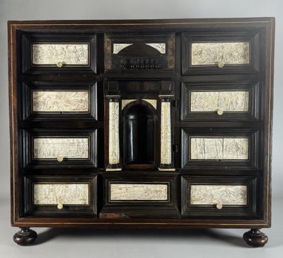 an image of a black and white chest of drawers with a clock on top of it