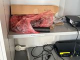 a shelf that has a laptop and other electronics on it
