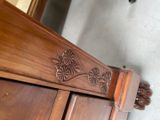 a close up of a wooden cabinet with carvings on it