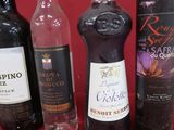 several bottles of wine are lined up on a red surface