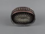 an antique silver and copper ring with a flower design