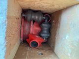 a box with a red valve and a black valve in it
